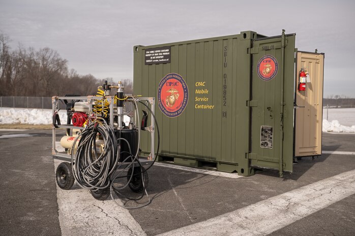Corrosion prevention and control equipment is displayed in front of a Corrosion Prevention and Control (CPAC) Mobile Service Container.