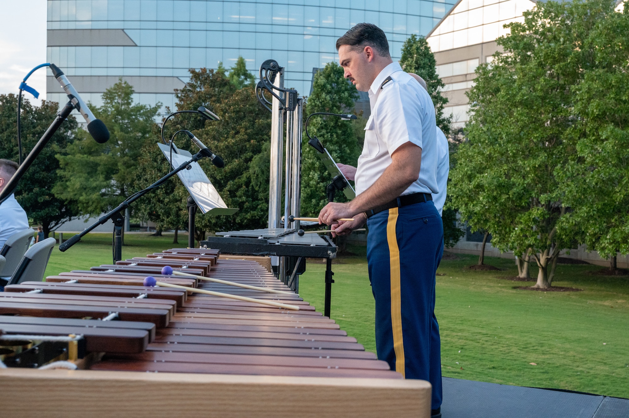 Two people play the xylophone.