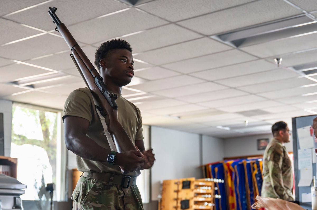 A U.S. Air Force honor guardsman in training with the Davis-Monthan Air Force Base Honor Guard, practices firing squad techniques at Davis-Monthan Air Force Base, Arizona, July 21, 2025. Honor guard members train extensively in firing squad techniques to deliver a precise and dignified final tribute. (U.S. Air Force photo by Airman Samantha Melecio)