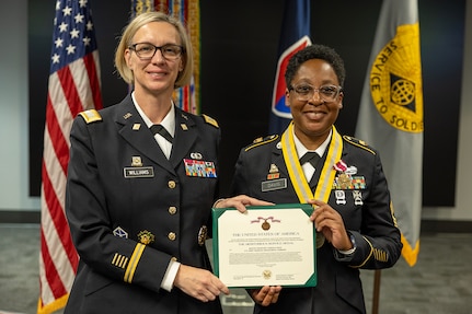Col. Michelle M. Williams, U.S. Army Financial Management Command commander, left, presents Master Sgt. Candace M. Davis, USAFMCOM Operational Support Team senior financial management systems instructor, a Meritorious Service Medal at the Maj. Gen. Emmett J. Bean Federal Center April 11, 2025. A native of Augusta, Georgia, Davis enlisted in the Army as a financial management specialist in October 2002. (U.S. Army photo by Mark R. W. Orders-Woempner)