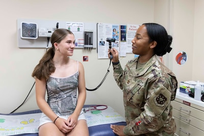 U.S. Air Force Capt. Brittany Hume-Dawson examines a patient during a routine checkup at the Walter Reed National Military Medical Center, Bethesda, Md., July 8, 2025. The staff from the Pediatric Department ensures a positive, family-centered experience from check-in to the end of your appointment and beyond. (DOD photo by Ann Brandstadter)