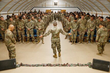 U.S. Army Maj. Troy Dandrea, brigade chaplain, 17th Sustainment Brigade, prays over Soldiers in the U.S. Central Command area of responsibility, Dec. 14, 2024.