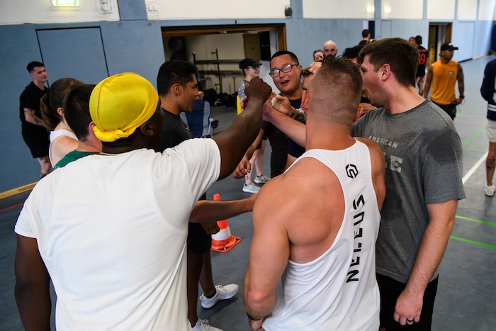 A team chants in a huddle after a game.