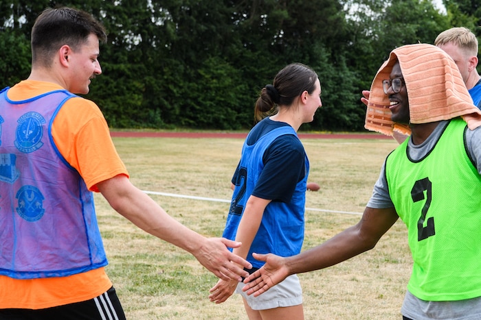 Two soccer players low-five each other.