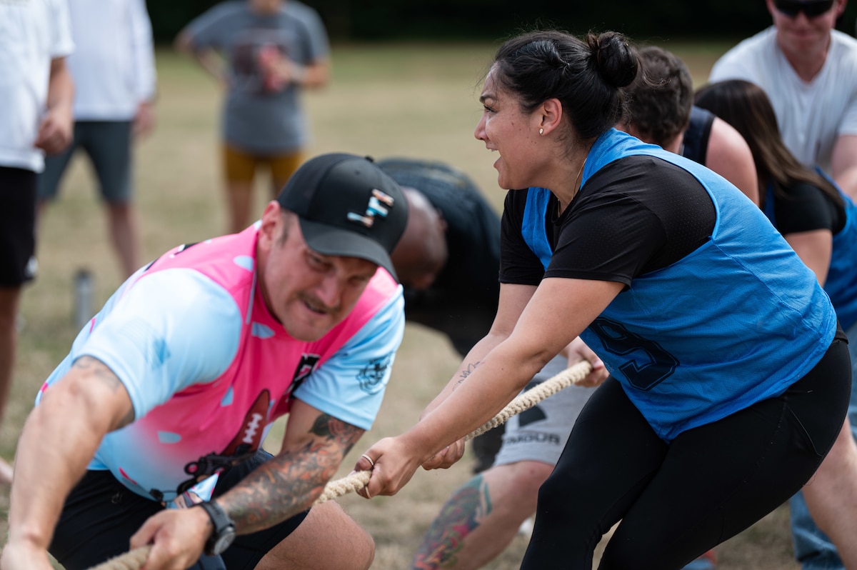 People pull on a tug-of-war rope.