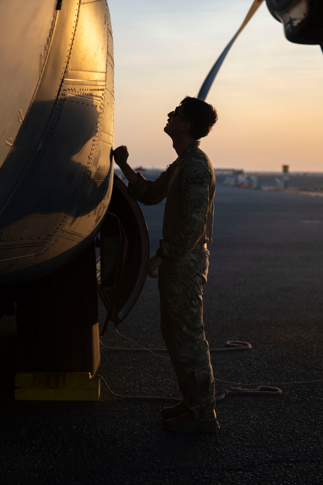 Airman performs pre-flight check on a C-130J