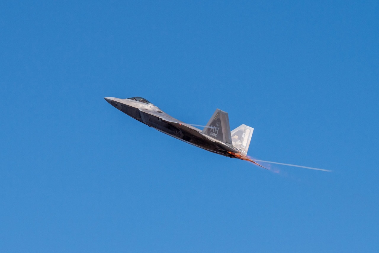 A jet takes off at a 45-degree angle against the backdrop of a blue sky.