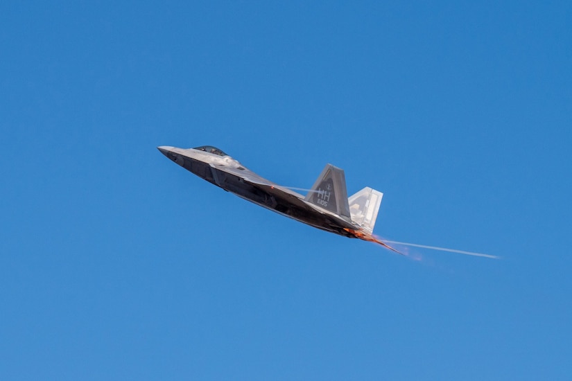 A jet takes off at a 45-degree angle against the backdrop of a blue sky.