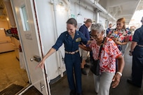 PUERTO PLATA, Dominican Republic (July 17, 2025) Cmdr. Anna Schlenker, director of medical operations and planning assigned to the Mercy-class hospital ship USNS Comfort (T-AH 20), assists a Dominican patient aboard Comfort in Puerto Plata, Dominican Republic during Continuing Promise 2025, July 17, 2025. Continuing Promise 2025 is the 16th iteration of the U.S. 4th Fleet/U.S. Naval Forces Southern Command-led mission since 2007, which aims to foster goodwill, strengthen existing partnerships with partner nations, and form new partnerships between host nations, non-federal entities, and international organizations. (U.S. Navy photo by Mass Communication Specialist 2nd Class Alfredo Marron)