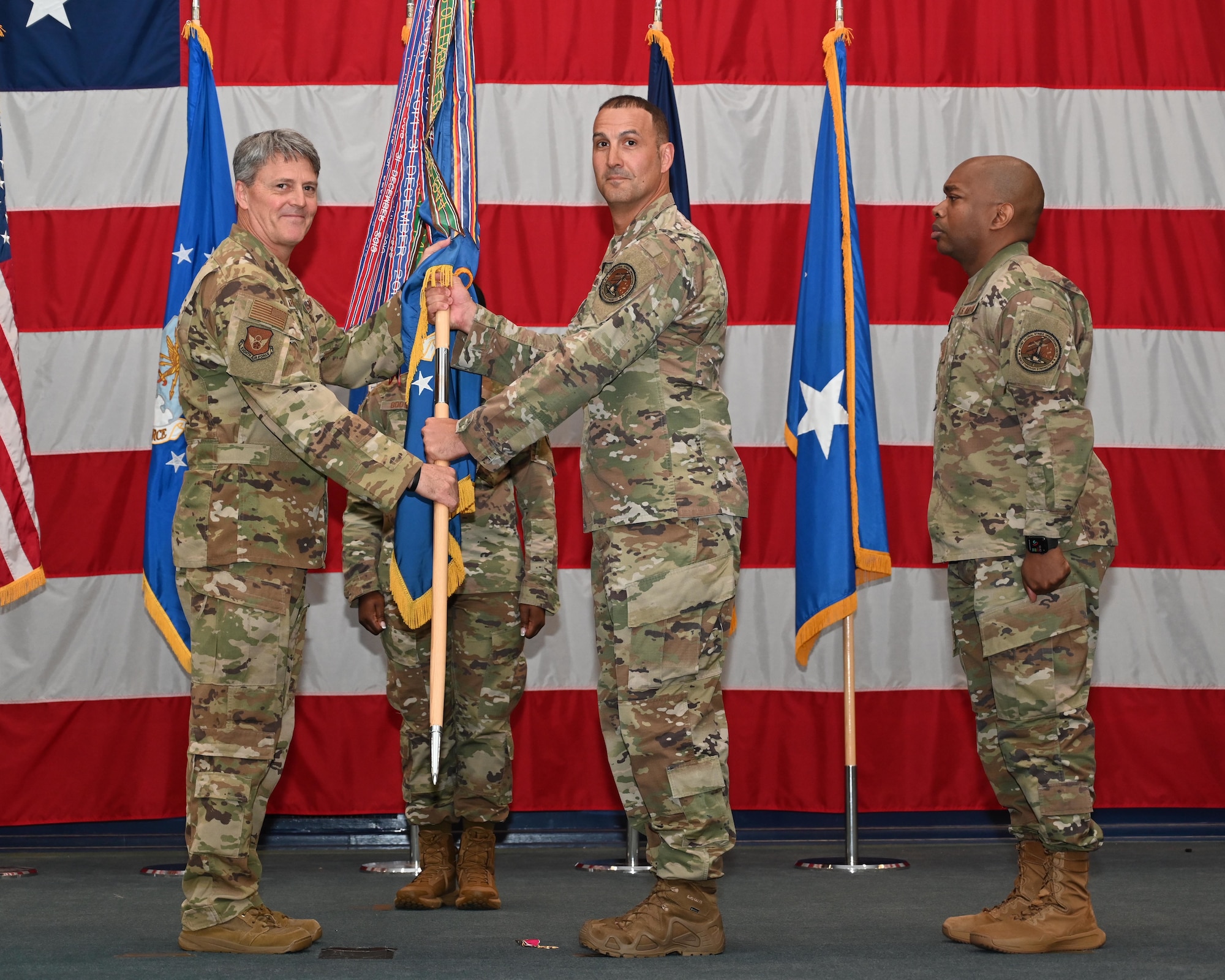 Maj. Gen. Armagost presents the guidon to Chief Master Sgt. Brandon Wolfgang