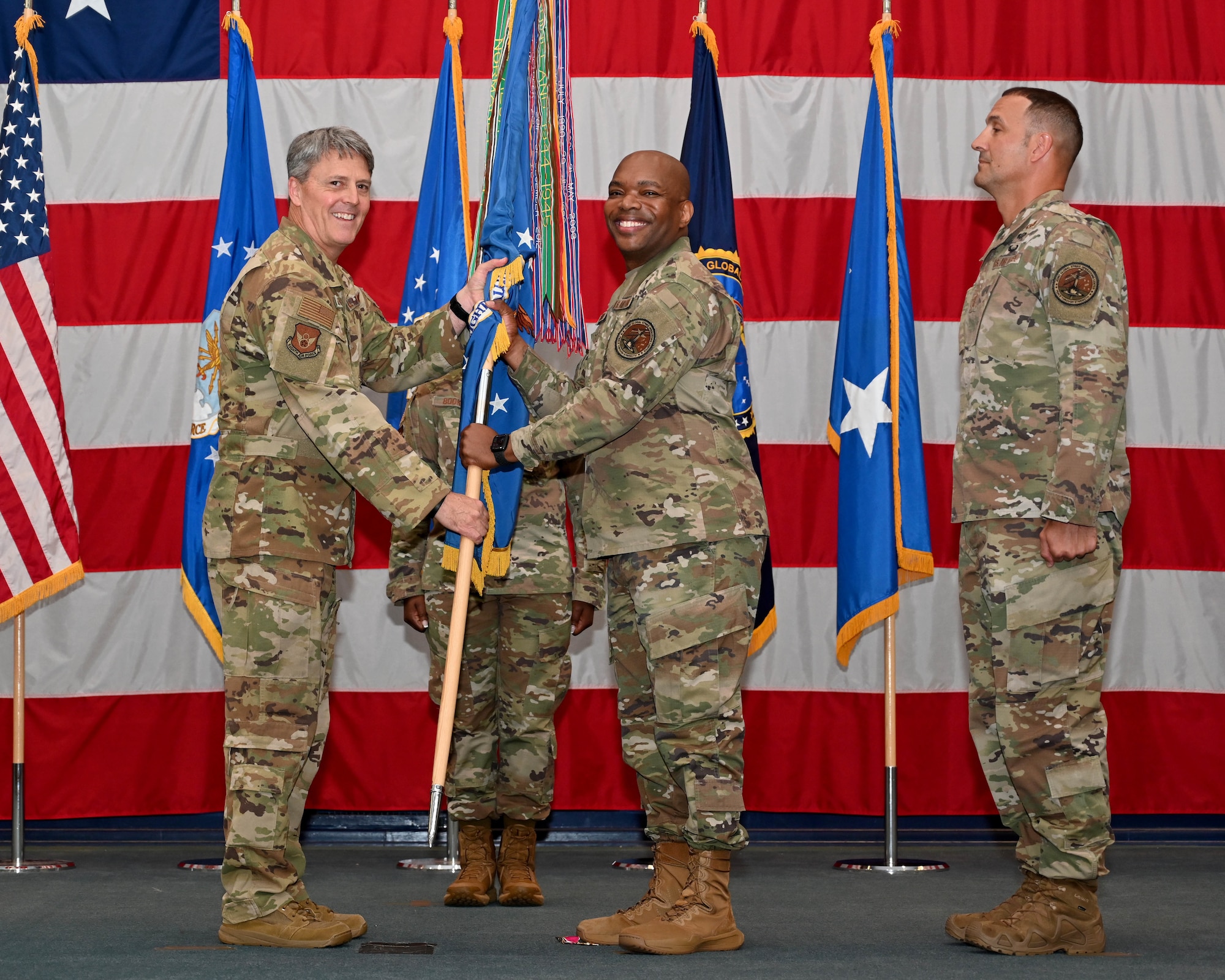 Maj. Gen. Armagost receives the guidon from Chief Master Sgt. Woods