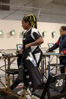 U.S. Army Retired Sgt. 1st Class Valerie Watkins puts on her shooting jacket for precision air event (air rifle) during the 2025 Department of Defense Warrior Games at Colorado Springs, Colorado, July 20, 2025.