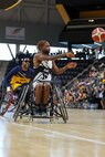 U.S. Army Staff Sgt. Allaijah Churchwell passes the ball to a teammate during a wheelchair basketball game against Team Navy at the 2025 Department of Defense Warrior Games at Colorado Springs, Colorado, July 20, 2025.