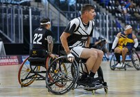 U.S. Army Staff Sgt. Coty Tuck looks for an opening during a wheelchair basketball game against Team Navy at the 2025 Department of Defense Warrior Games at Colorado Springs, Colorado, July 20, 2025.