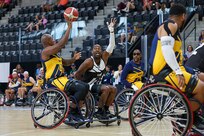 U.S. Army Staff Sgt. Derrick Thompson tries to block a shot during the wheelchair basketball games against Team Navy at the 2025 Department of Defense Warrior Games at Colorado Springs, Colorado, July 20, 2025.