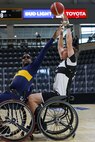 U.S. Army Staff Sgt. Coty Tuck shoots the ball over a defender during a wheelchair basketball game against Team Navy at the 2025 Department of Defense Warrior Games at Colorado Springs, Colorado, July 20, 2025.