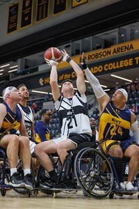 U.S. Army Staff Sgt. Coty Tuck attempts a shot during the wheelchair basketball game against Team Navy at the 2025 Department of Defense Warrior Games at Colorado Springs, Colorado, July 20, 2025.