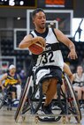 U.S. Army Retired Spc. Anthony Farve makes a move towards the basket during a wheelchair basketball game against Team Navy at the 2025 Department of Defense Warrior Games at Colorado Springs, Colorado, July 20, 2025.