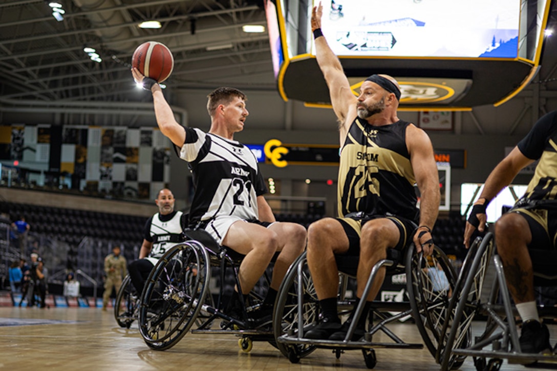 U.S. Army Staff Sgt. Coty Tuck looks to pass the ball during the wheelchair basketball gold medal game against Team SOCOM at the 2025 Department of Defense Warrior Games in Colorado Springs Colorado, July 20, 2025.