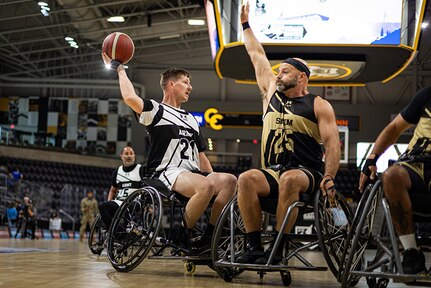 U.S. Army Staff Sgt. Coty Tuck looks to pass the ball during the wheelchair basketball gold medal game against Team SOCOM at the 2025 Department of Defense Warrior Games in Colorado Springs Colorado, July 20, 2025.