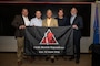 Members of Lt. Col. James Summersett’s family pose with the 96th Bomb Squadron flag
