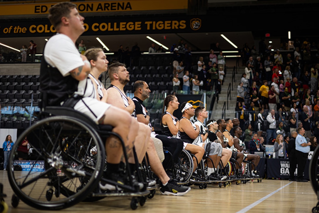 Team Army athletes hold their hands over their hearts during the national anthem before the wheelchair basketball gold medal game at the 2025 Department of Defense Warrior Games in Colorado Springs Colorado, July 20, 2025.