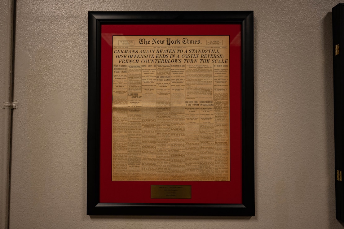A copy of The New York Times from 1918 hangs from the wall