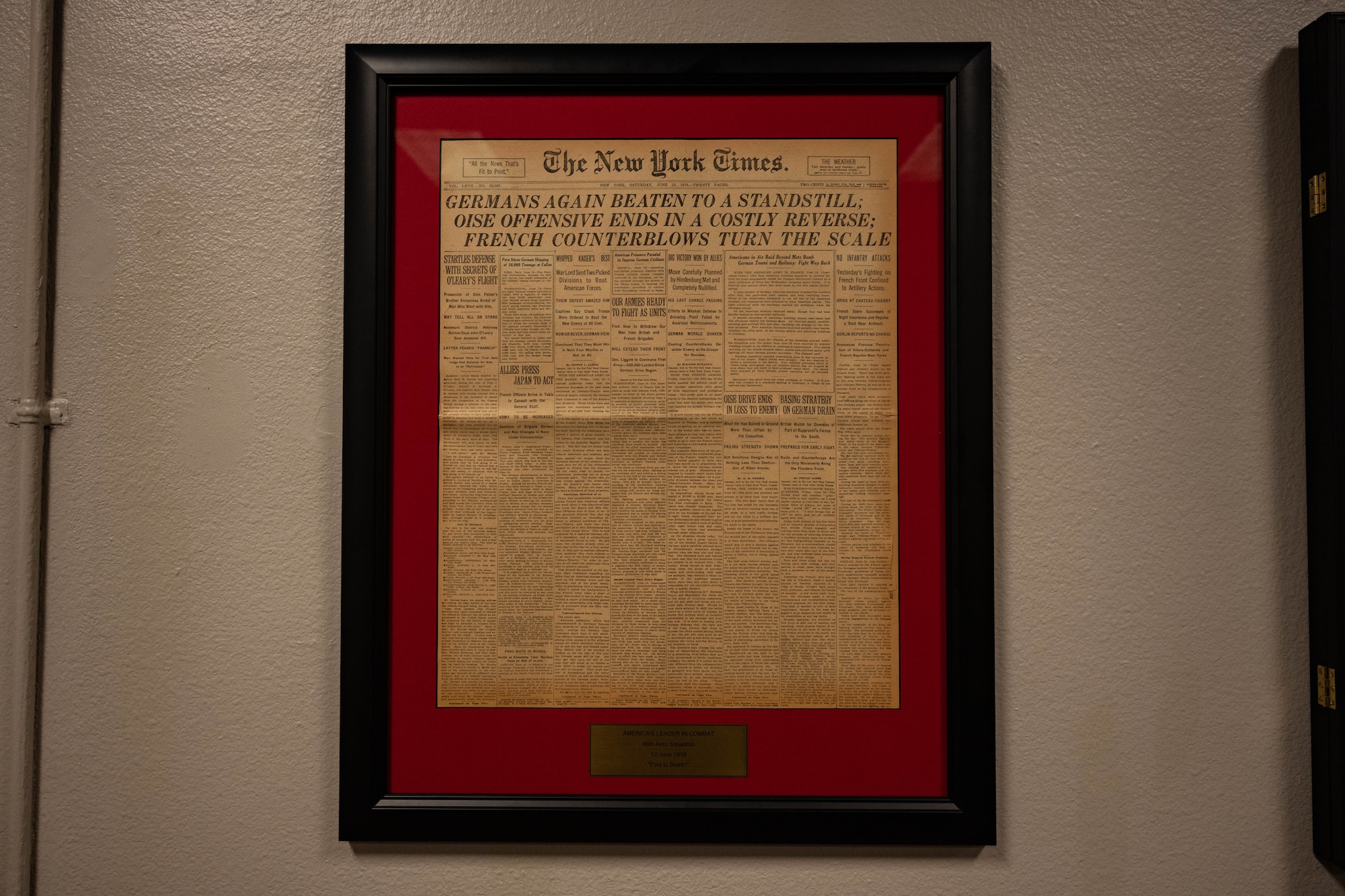 A copy of The New York Times from 1918 hangs from the wall