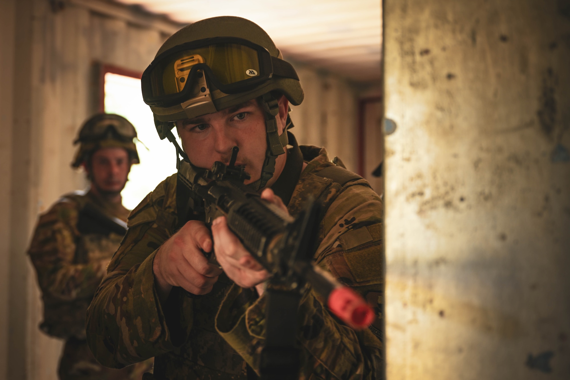 Men in uniform clear a building.