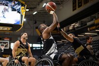 U.S. Army Staff Sgt. Derrick Thompson shoots over a Team SOCOM defender during the wheelchair basketball gold medal game at the 2025 Department of Defense Warrior Games in Colorado Springs Colorado, July 20, 2025.
