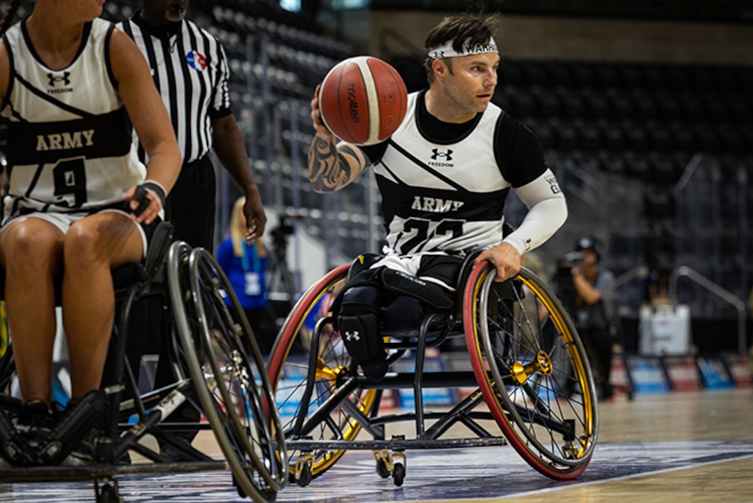 U.S. Army Retired Spc. JP Lane takes the basketball up court during the wheelchair basketball gold medal game against Team SOCOM at the 2025 Department of Defense Warrior Games in Colorado Springs Colorado, July 20, 2025.