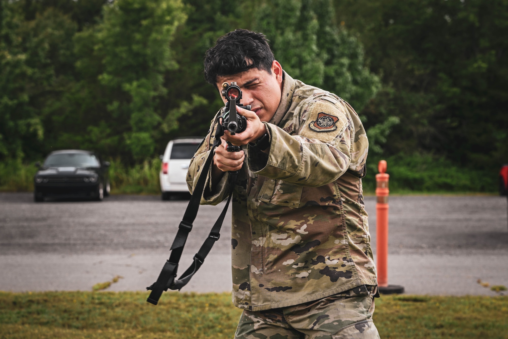 A man in uniform holds a rifle.