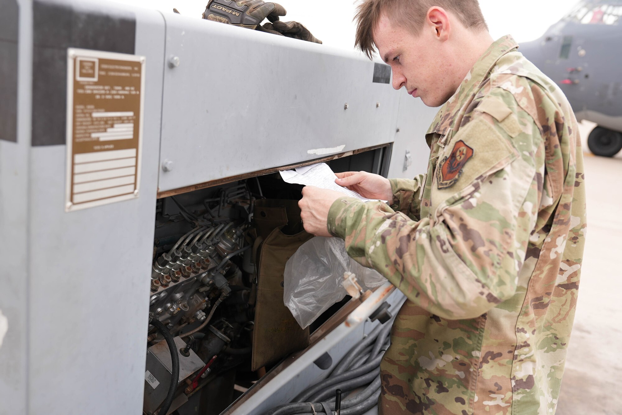 An Air Commando assigned to the 27th Special Operations Wing inspects the forms for a power cart at Cannon Air Force Base, New Mexico, July 1, 2025. Earlier this year, the AGE flight implemented a new inspection process of its more than 900-asset equipment account, driving a 74% increase in inspection productivity. (U.S. Air Force photo by Staff Sgt. Kevin Williams)