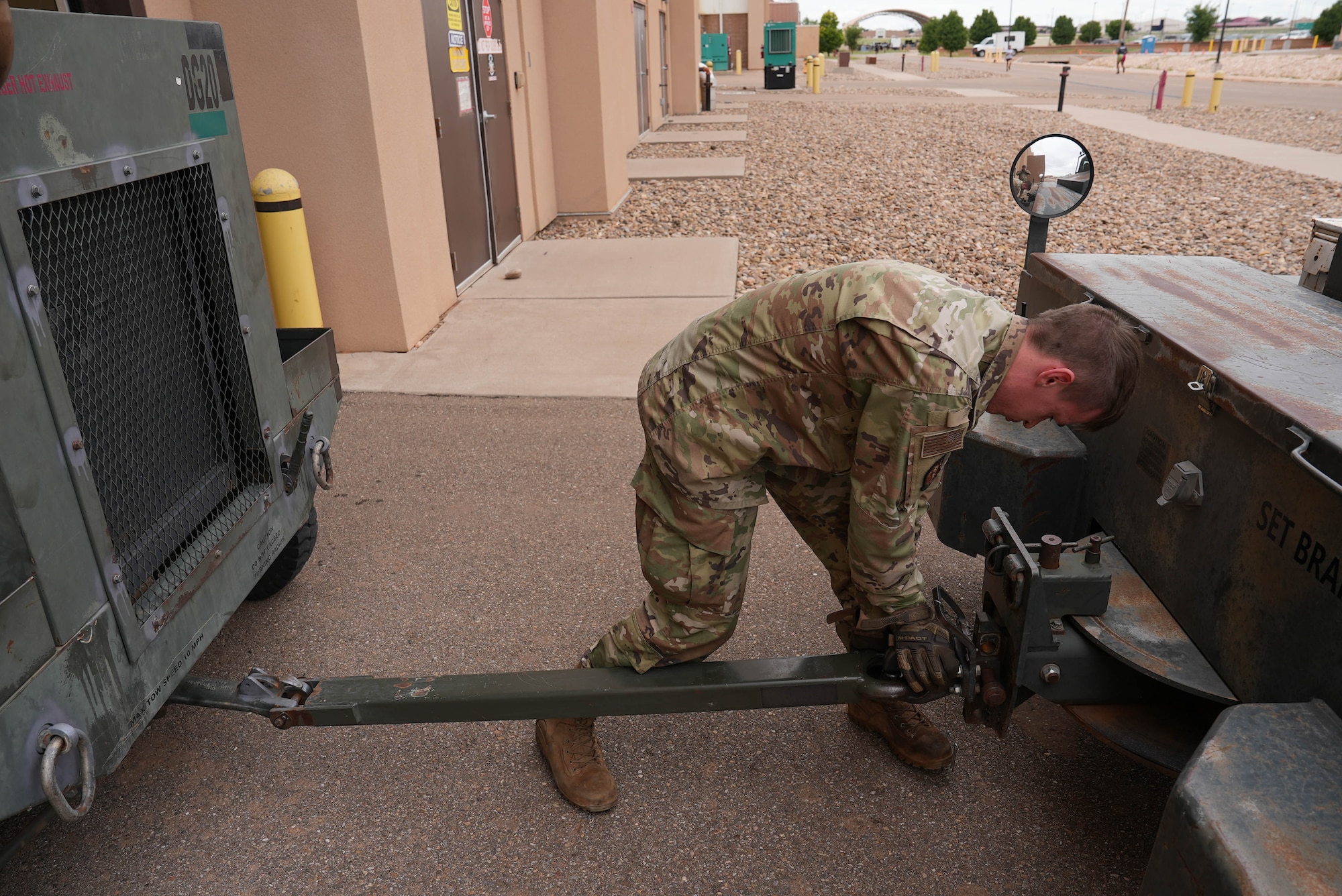 An Air Commando assigned to the 27th Special Operations Wing prepares an aerospace ground equipment asset for towing at Cannon Air Force Base, New Mexico, July 1, 2025. The AGE flight assigned to the 27th SOW has completed half of its annual inspection schedule – a milestone not reached since 2018 – following the implementation of a new streamlined process in March 2025. (U.S. Air Force photo by Staff Sgt. Kevin Williams)