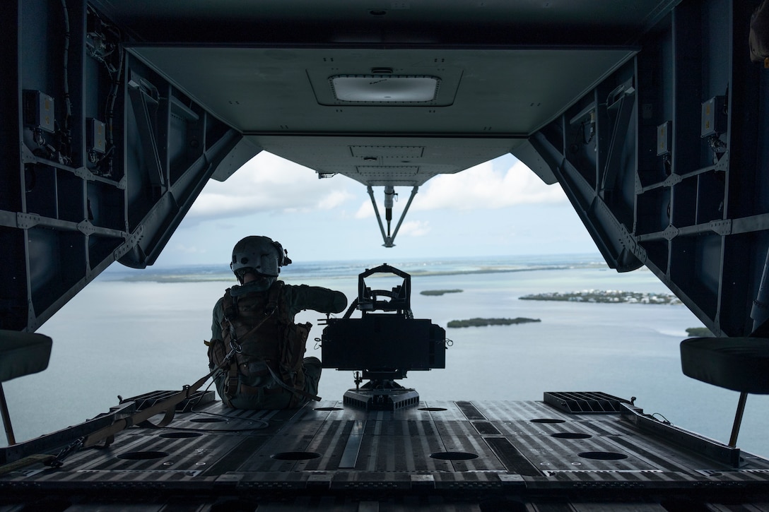 U.S. Marine Corps Staff Sgt. Fred Miller, from Nevada and a CH-53K King Stallion crew chief with Marine Heavy Helicopter Squadron (HMH) 461, looks out of a CH-53K near Naval Air Station Key West, Florida, July 21, 2025. Marines with 2nd Marine Aircraft Wing and 2nd Distribution Support Battalion are training with elements of the U.S. Army, U.S. Navy, and U.S. Customs and Border Protection to refine humanitarian assistance and disaster relief capabilities while also refining the CH-53K’s ability to support distributed aviation operations in a joint environment. (U.S. Marine Corps photo by Cpl. Mya Seymour)