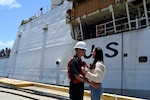 Petty Officer 3rd Class Lucas Ritch, a boatswainmate aboard the U.S. Coast Guard Cutter Munro (WMSL 755), reunites with a loved one upon the cutter's return to home port in Alameda, California, July 16, 2025. The Munro returned to their home port following a 20,000-nautical-mile, 121-day deployment patrolling the Bering Sea. (U.S. Coast Guard photo by Petty Officer 3rd Class Joel LaVallee)