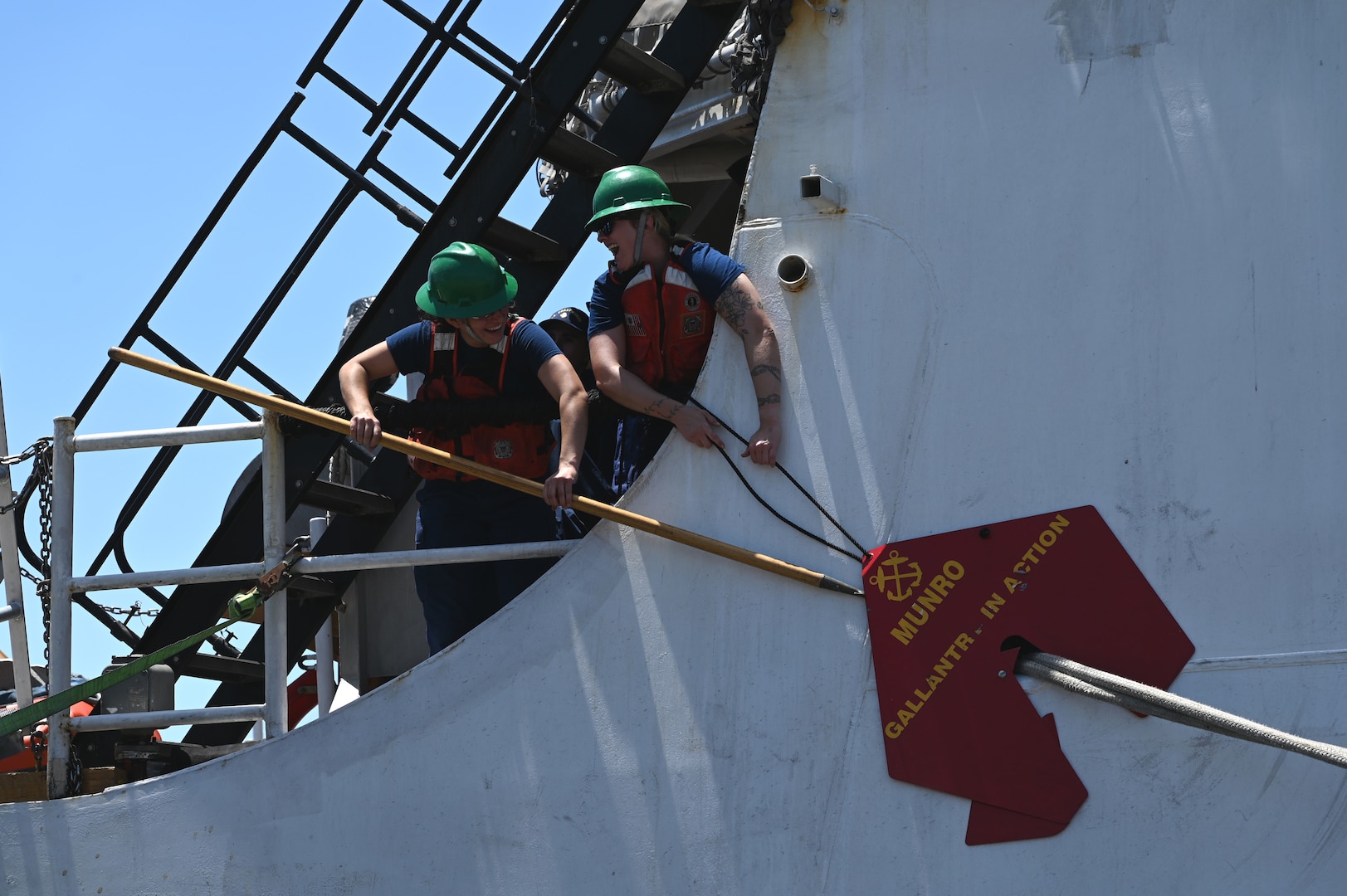 Members aboard the U.S. Coast Guard Cutter Munro (WMSL 755) assist with lines while returning to home port in Alameda, California, July 16, 2025. The Munro returned to their home port following a 20,000-nautical-mile, 121-day deployment patrolling the Bering Sea. (U.S. Coast Guard photo by Petty Officer 3rd Class Joel LaVallee)