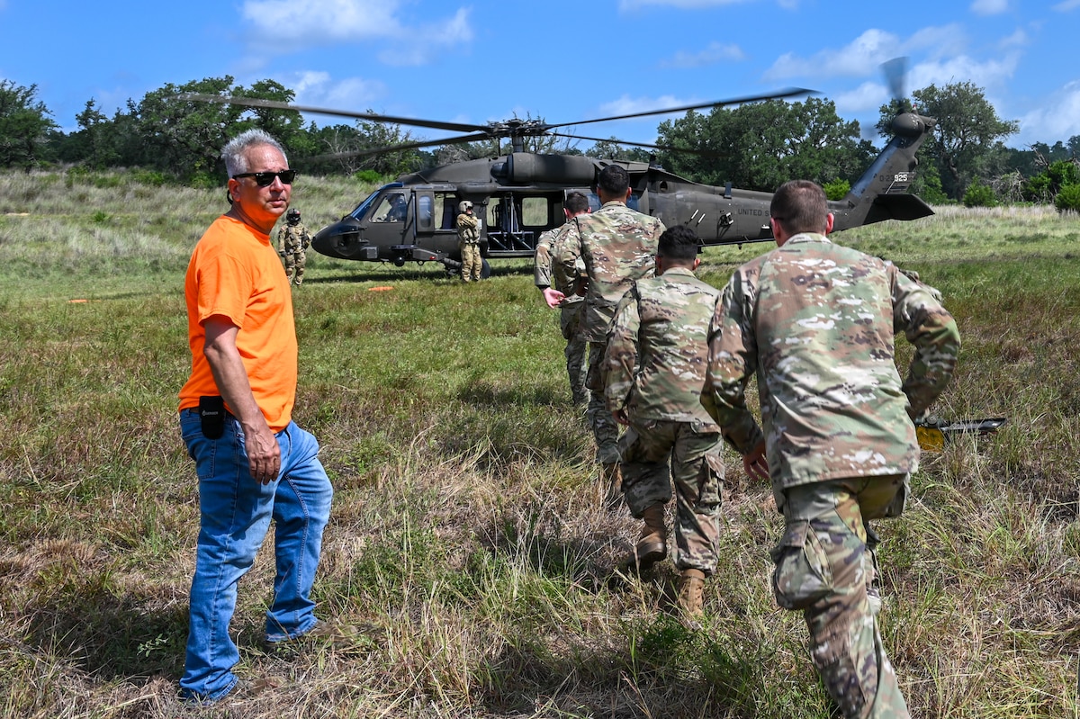 Kjäll Gopaul, Department of Defense senior civilian pathfinder, directs U.S. Air Force personnel during simulated medical evacuation procedures for OPERATION DUSTOFF VIGILANCE ’25 at Joint Base San Antonio-Camp Bullis, Texas, July 16, 2025.