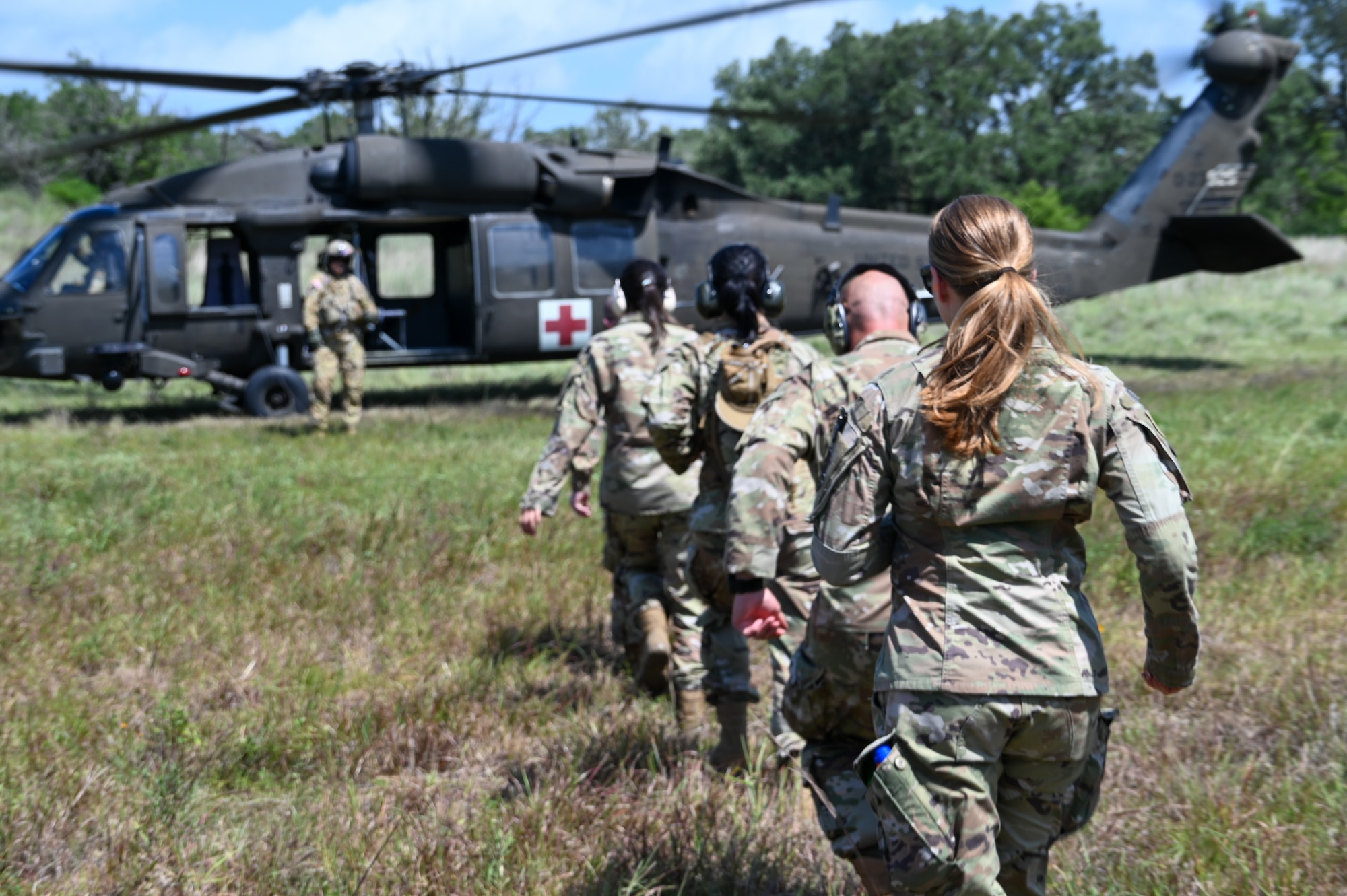 Master Sgt. Thea Lau, 26th Aerial Port Squadron Readiness and Resources flight chief, leads her Airmen in a simulated Army medevac during OPERATION DUSTOFF VIGILANCE ’25 at Joint Base San Antonio-Camp Bullis, Texas, July 16, 2025.