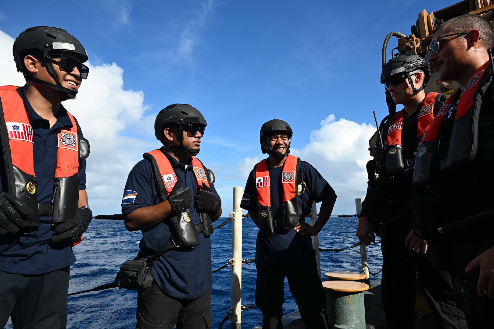 Officers from the Republic of the Marshall Islands (RMI) Sea Patrol and U.S. Coast Guard crew members assigned to the Legend-class U.S. Coast Guard Cutter Stratton (WMSL 752), conduct a debrief following a fisheries boarding within RMI’s exclusive economic zone, July 10, 2025. The U.S. Coast Guard and the RMI have long cooperated to enhance maritime security and sovereignty in the Pacific with a focus on bilateral maritime law enforcement operations that help combat maritime trafficking and safeguard fisheries for both countries. (U.S. Coast Guard photo by Petty Officer 2nd Class Kate Kilroy)