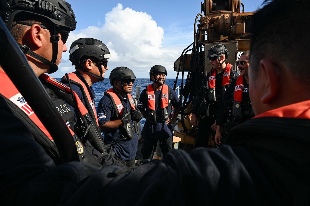 Officers from the Republic of the Marshall Islands (RMI) Sea Patrol and U.S. Coast Guard crew members assigned to the Legend-class U.S. Coast Guard Cutter Stratton (WMSL 752), conduct a debrief following a fisheries boarding within RMI’s exclusive economic zone, July 10, 2025. The U.S. Coast Guard and the RMI have long cooperated to enhance maritime security and sovereignty in the Pacific with a focus on bilateral maritime law enforcement operations that help combat maritime trafficking and safeguard fisheries for both countries. (U.S. Coast Guard photo by Petty Officer 2nd Class Kate Kilroy)