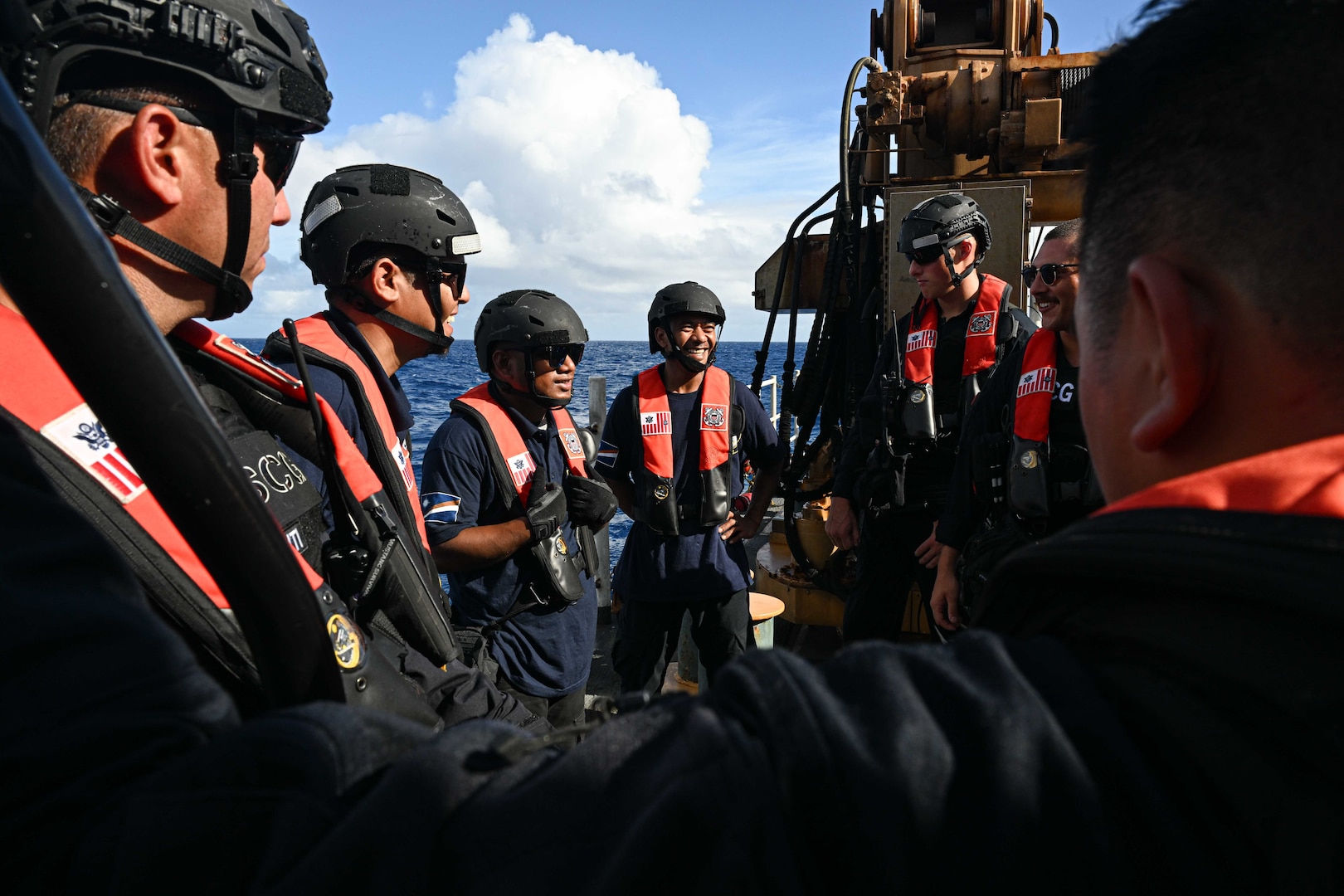 Officers from the Republic of the Marshall Islands (RMI) Sea Patrol and U.S. Coast Guard crew members assigned to the Legend-class U.S. Coast Guard Cutter Stratton (WMSL 752), conduct a debrief following a fisheries boarding within RMI’s exclusive economic zone, July 10, 2025. The U.S. Coast Guard and the RMI have long cooperated to enhance maritime security and sovereignty in the Pacific with a focus on bilateral maritime law enforcement operations that help combat maritime trafficking and safeguard fisheries for both countries. (U.S. Coast Guard photo by Petty Officer 2nd Class Kate Kilroy)
