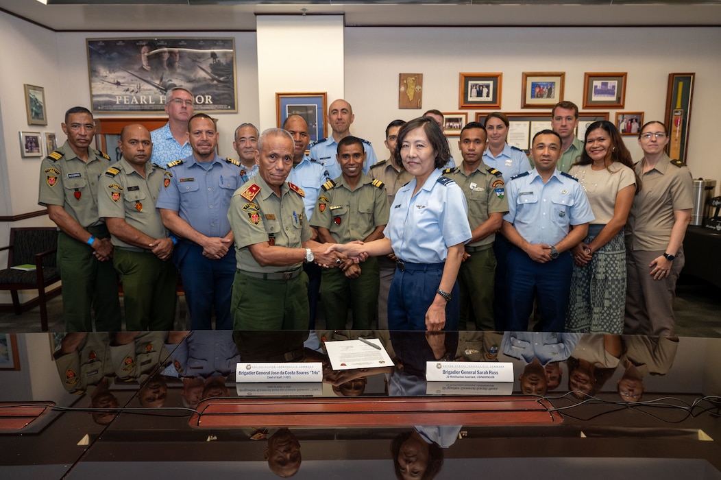 U.S. Air Force Brig. Gen. Sarah Russ, USINDOPACOM J5 Mobilization Assistant and Brig. Gen. Jose da Costa Soares, Chief of Staff of the Timor-Leste Defence Force shake hands during a Bilateral Defense Discussion at USINDOPACOM headquarters on Camp H.M. Smith in Honolulu, July 21-22, 2025.