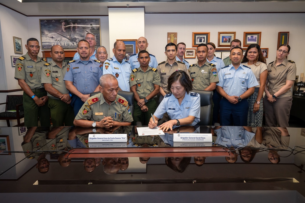 U.S. Air Force Brig. Gen. Sarah Russ, USINDOPACOM J5 Mobilization Assistant and Brig. Gen. Jose da Costa Soares, Chief of Staff of the Timor-Leste Defence Force sign a document during a Bilateral Defense Discussion at USINDOPACOM headquarters on Camp H.M. Smith in Honolulu, July 21-22, 2025.