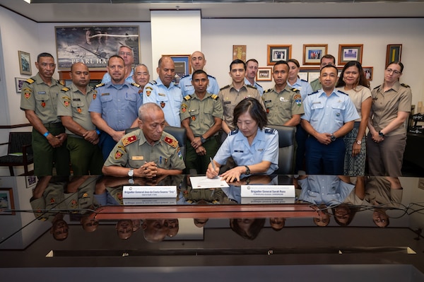 U.S. Air Force Brig. Gen. Sarah Russ, USINDOPACOM J5 Mobilization Assistant and Brig. Gen. Jose da Costa Soares, Chief of Staff of the Timor-Leste Defence Force sign a document during a Bilateral Defense Discussion at USINDOPACOM headquarters on Camp H.M. Smith in Honolulu, July 21-22, 2025.