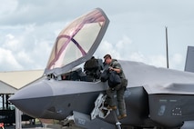 U.S. Air Force Capt. Tyler Rico, 421st Mission Generation Force Element F-35A Lightning II pilot, climbs into the cockpit of his aircraft during Cope Thunder 25-2 on the flightline of Clark Air Base, Philippines, July 7, 2025.