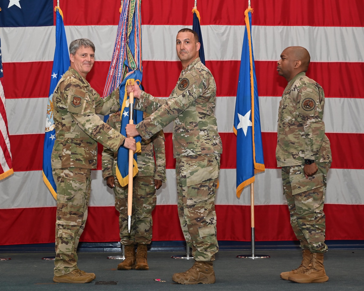 Maj. Gen. Armagost presents the guidon to Chief Master Sgt. Brandon Wolfgang