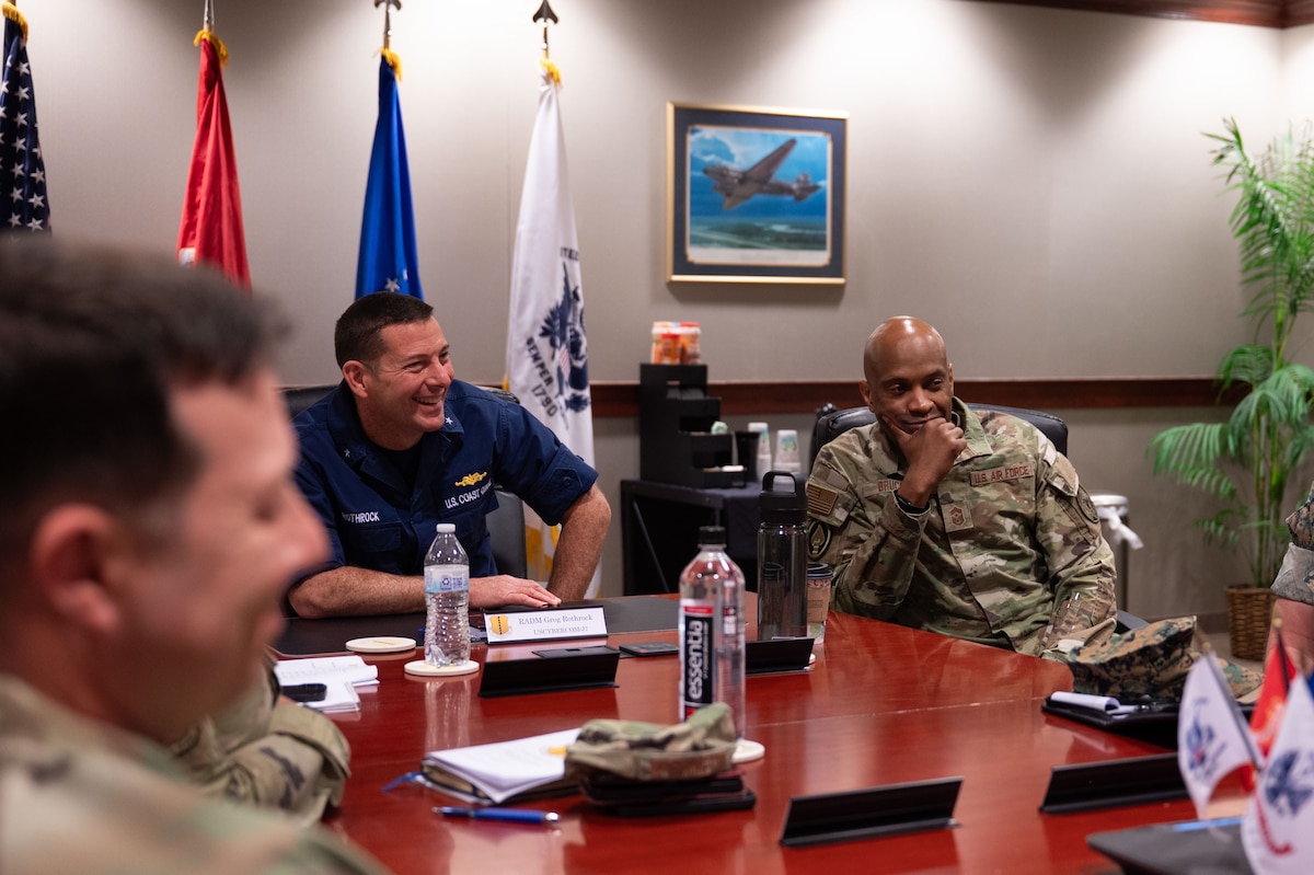 U.S. Coast Guard Rear Adm. Greg Rothrock, U.S. Cyber Command J7 Director of Force Development, and U.S. Air Force Chief Master Sgt. Kenneth Bruce, Command Senior Enlisted Leader, USCYBERCOM and Director's Senior Enlisted Advisor, National Security Agency/Commander’s Support Staff, discuss the joint training environment with 17th Training Wing Leadership during the 17th TRW mission brief at the Norma Brown headquarters building, Goodfellow Air Force Base, Texas, May 20, 2025. The Wing Mission Brief allowed for RDML Rothrock and CMSgt Bruce to better understand how Goodfellow integrates joint intelligence, reconnaissance and surveillance warriors to build a foundational standard across the ISR community. (U.S. Air Force photo by Airman 1st Class Brian Lummus)
