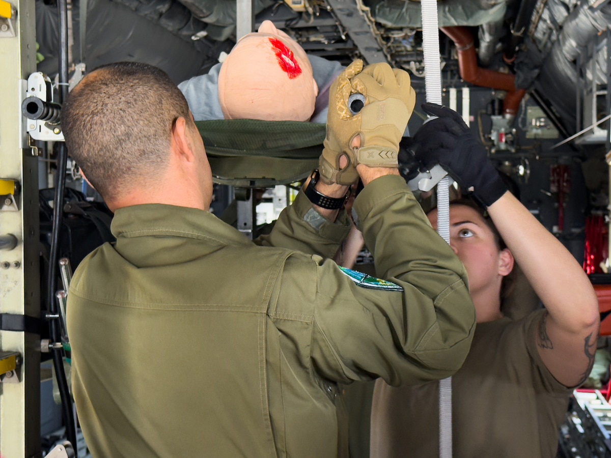 U.S. Air Force and Algerian aeromedical personnel secure a medical mannequin on a static C-130 Hercules during training as part of an Algerian aeromedical evacuation familiarization visit at Ramstein Air Base, Germany, July 17, 2025. The familiarization visit, led by the U.S. Air Forces in Europe – Air Forces Africa Command Surgeon’s Office of Global Health Engagements and the 86th Aeromedical Evacuation Squadron, provided an opportunity to exchange aeromedical training and best practices, serving as a foundation for future military healthcare cooperation.