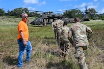 Kjäll Gopaul, Department of Defense senior civilian pathfinder, directs U.S. Air Force personnel during simulated medical evacuation procedures for OPERATION DUSTOFF VIGILANCE ’25 at Joint Base San Antonio-Camp Bullis, Texas, July 16, 2025.